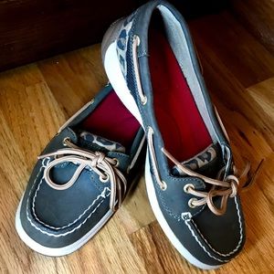 Brown Sperry slip-ons.